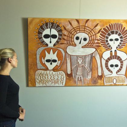 Tourist enjoying Wandjina artworks by Donny Woolagoodja (left) and Pudja Barunga at the Mowanjum Art and Culture Centre, located in Derby